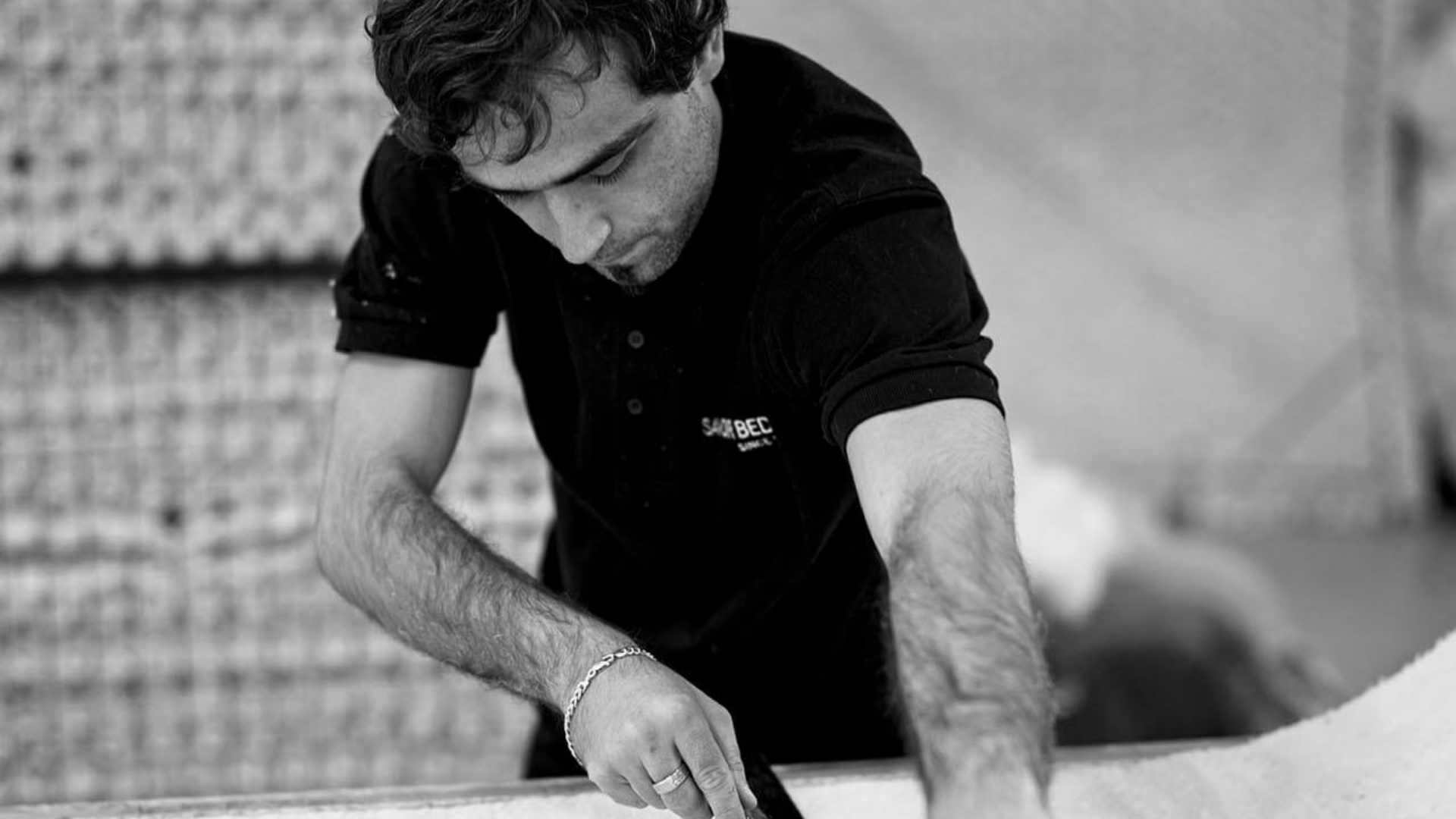 Craftsman working on durable wool for a savoir bed